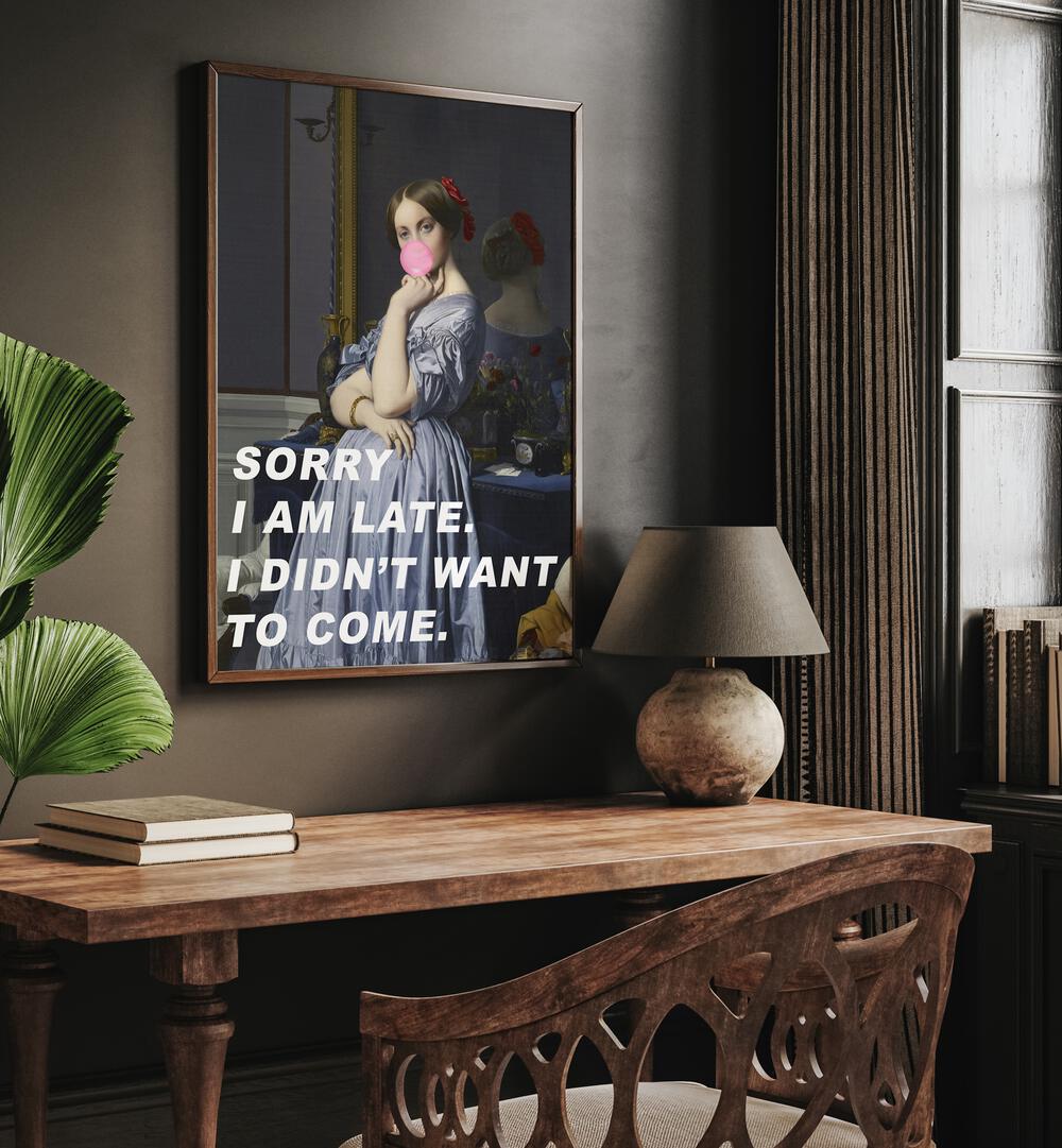 Sorry I Am Late I Didn't Want to Come by the Art Concept Altered Art Prints in Dark Wood Plain Frame placed on the wall above a study table