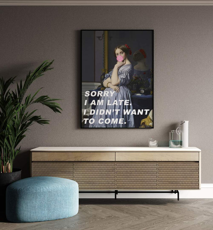 Sorry I Am Late I Didn't Want to Come by the Art Concept Altered Art Prints in Black Plain Frame placed on a wall behind a console table