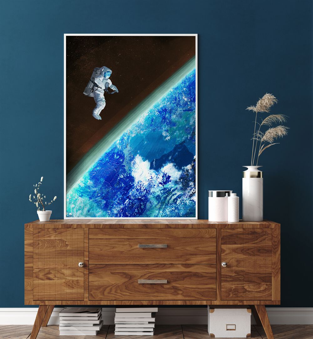 Space Walk By Goed Blauw Sci-fi-posters Wall Art Prints in White Plain Frame placed on a Console Table near a Blue Colored Wall in the Drawing Room