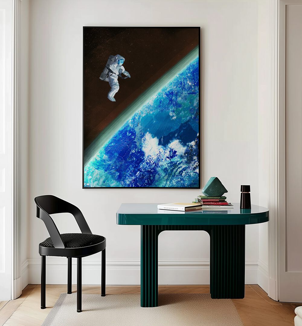 Space Walk By Goed Blauw Sci-fi-posters Wall Art Prints in Black Plain Frame placed on a Cream Colored Wall near a Study Table in the Work Space in the Drawing Room