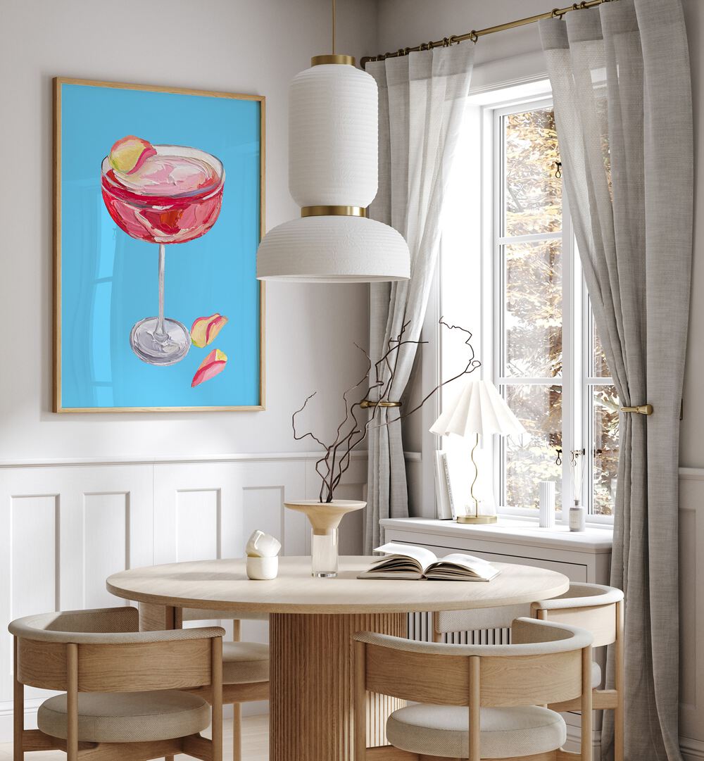 Sparkling Rose Gin Cocktail by Alice Straker Bar Posters Bar Art Prints in Oak Wood Plain Frame placed on a wall in a dining room area beside a window and behind a dining table