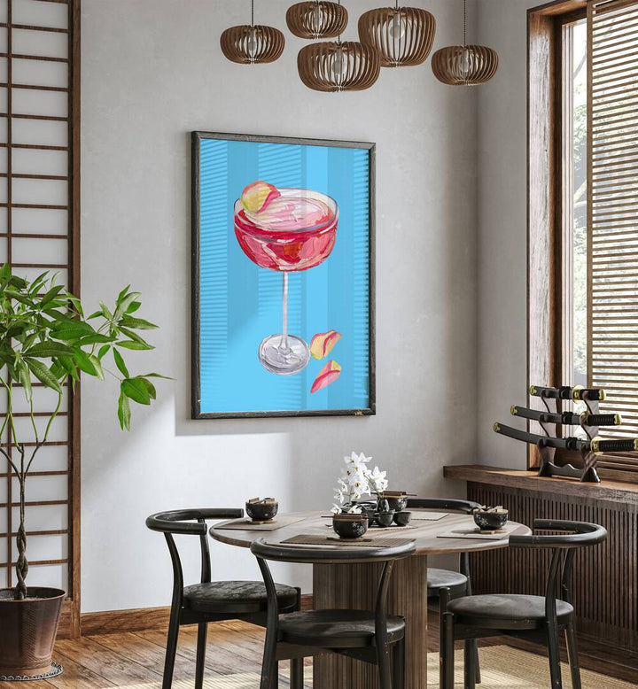 Sparkling Rose Gin Cocktail by Alice Straker Bar Posters Bar Art Prints in Black Plain Frame placed on a wall in a dining room area beside a window and behind a dining table