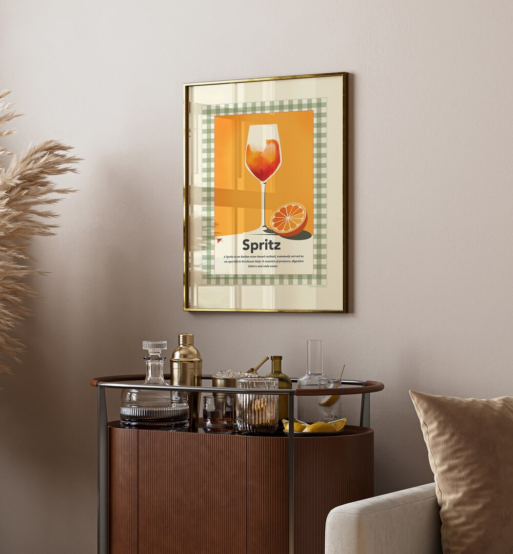 Spritz Retro Print by Studio Mandariini Kitchen Posters Kitchen Art Prints in Gold Plain Frame placed on a wall behind a table and beside a sofa