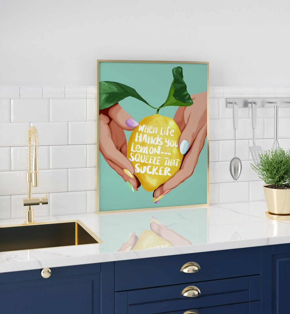 Squeeze That Lemon Kitchen Posters Kitchen Art Prints in Gold Plain Frame placed on a Console Table in the Kitchen