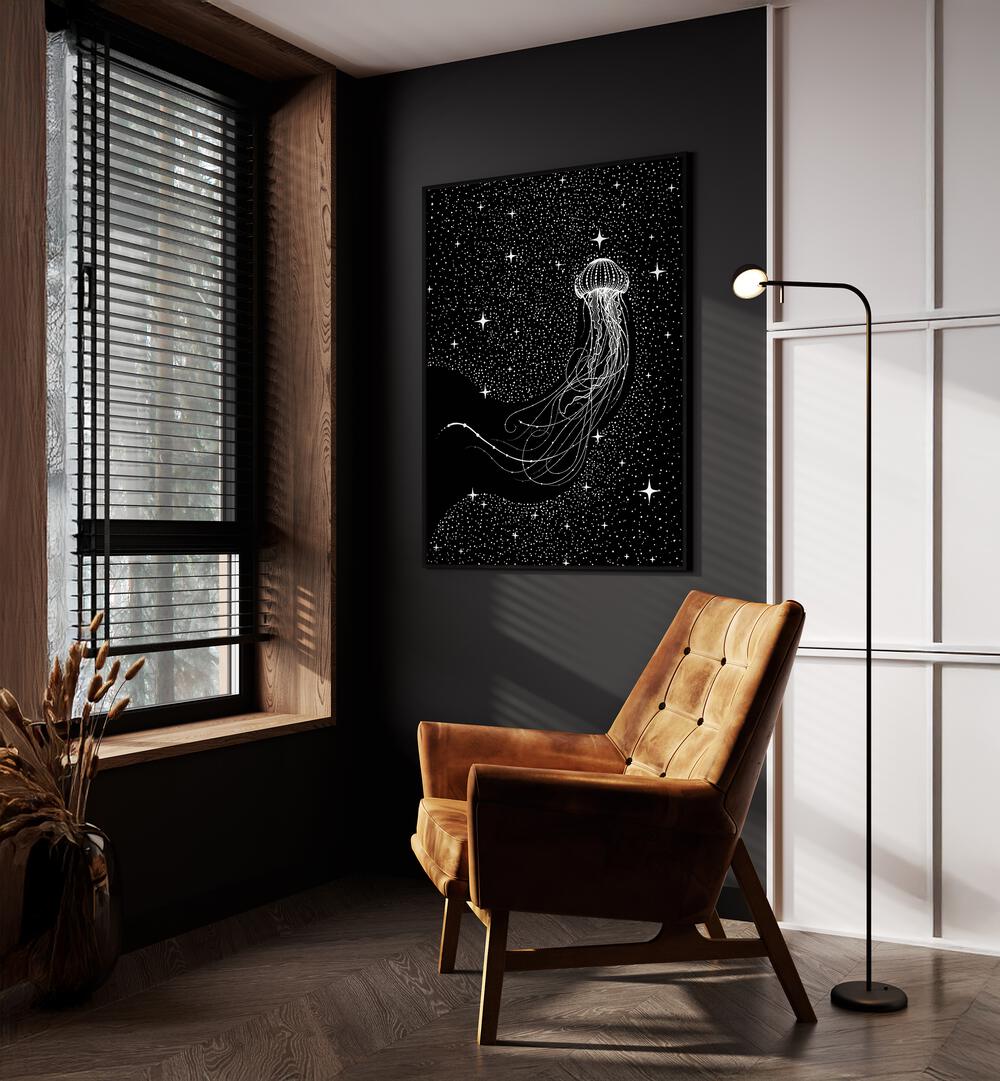 Starry Jellyfish Black Version By Aliriza Cakir Surreal Paintings Surreal Art in Black Plain Frame placed on a Dark Grey Colored Wall near a Brown Sofa Chair in the Drawing Room