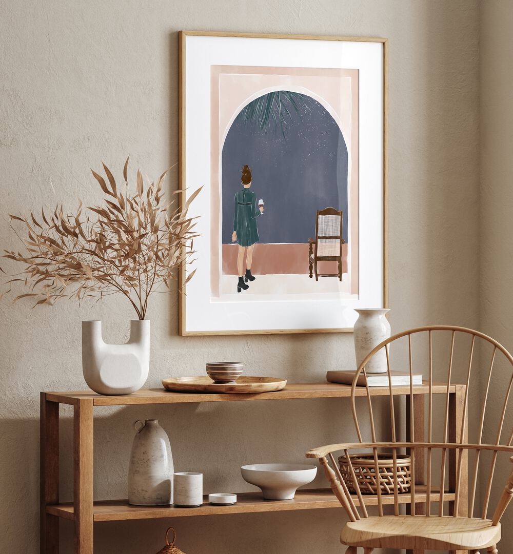 Starry Night By Ivy Green Women Illustration Paintings in Oak Wood Frame With Mount on a cream wall above a table