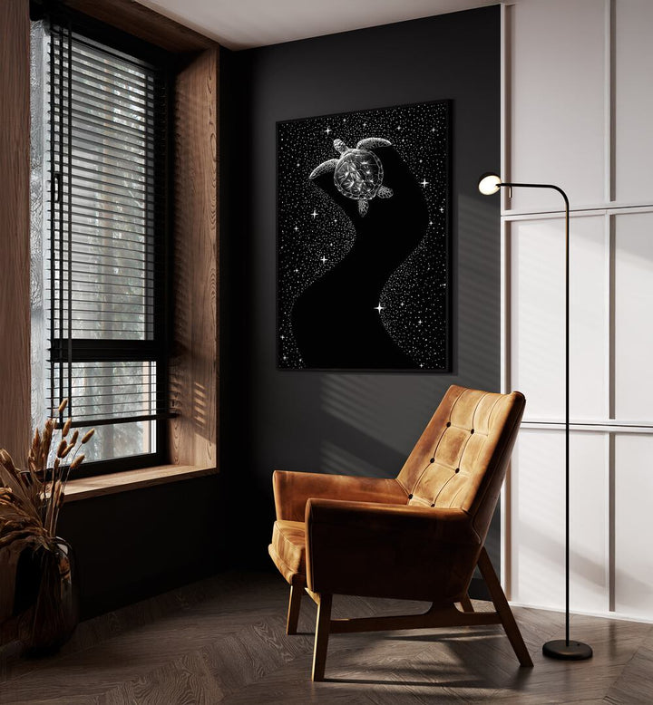 Starry Turtle Black Version By Aliriza Cakir Surreal Paintings Surreal Art in Black Plain Frame placed on a Dark Grey Colored Wall near a Brown Sofa Chair in the Drawing Room