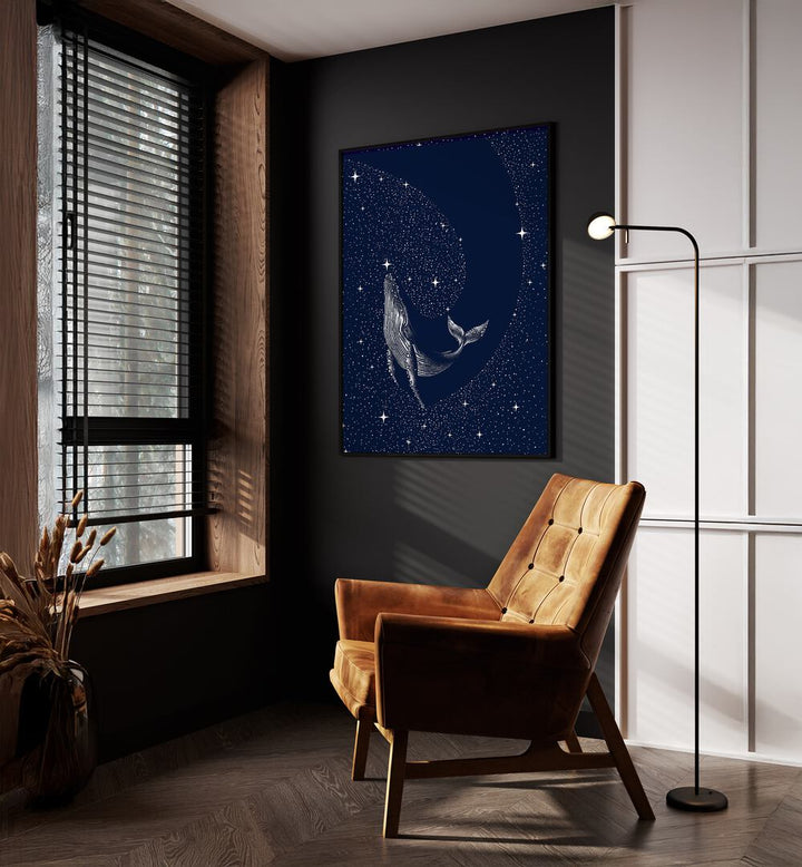 Starry Whale By Aliriza Çakir Surreal Paintings Surreal Art in Black Plain Frame placed on a Dark Grey Colored Wall near a Brown Sofa Chair in the Drawing Room