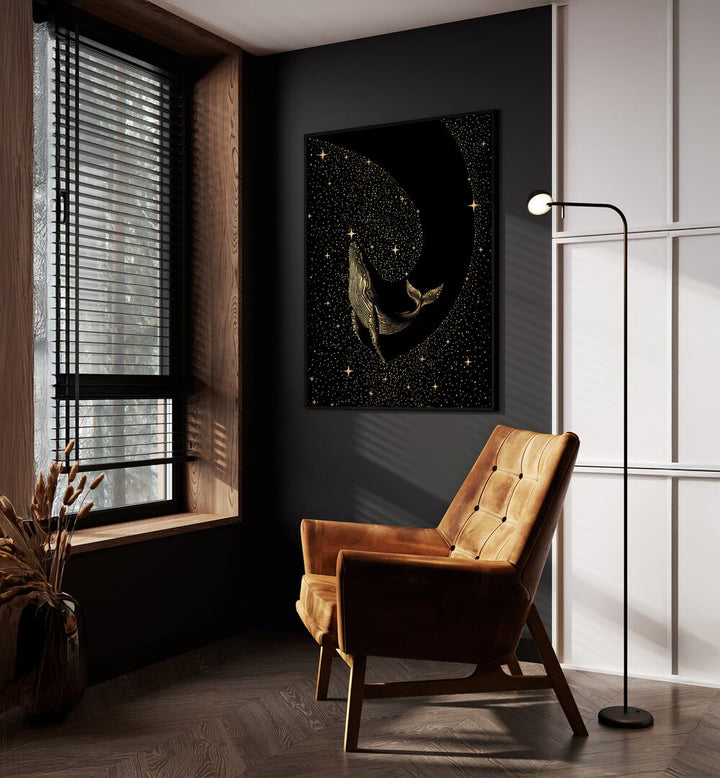 Starry Whale Dark Gold Version By Aliriza Çakir Surreal Paintings Surreal Art in Black Plain Frame placed on a Dark Grey Colored Wall near a Brown Sofa Chair in the Drawing Room