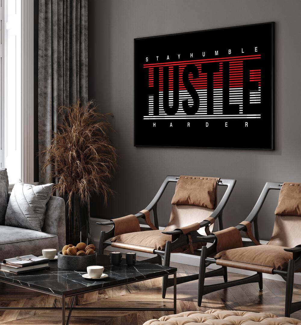 Stay Humble Hustle Harder ii Quotes and Typography Posters in Black Plain Frame placed on a wall in living room behind chairs