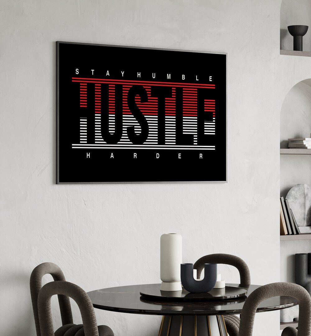 Stay Humble Hustle Harder ii Quotes and Typography Posters in Black Plain Frame placed on a wall behind a dining table 