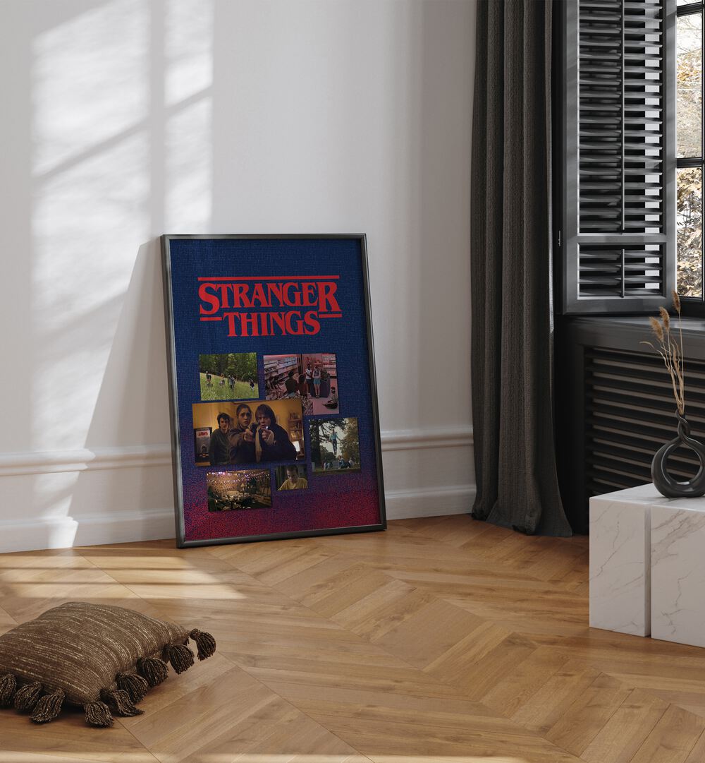 Stranger Things By Grishma Korjani Movie Posters in Black Plain Frame placed on a Wooden Floor near a White Colored Wall