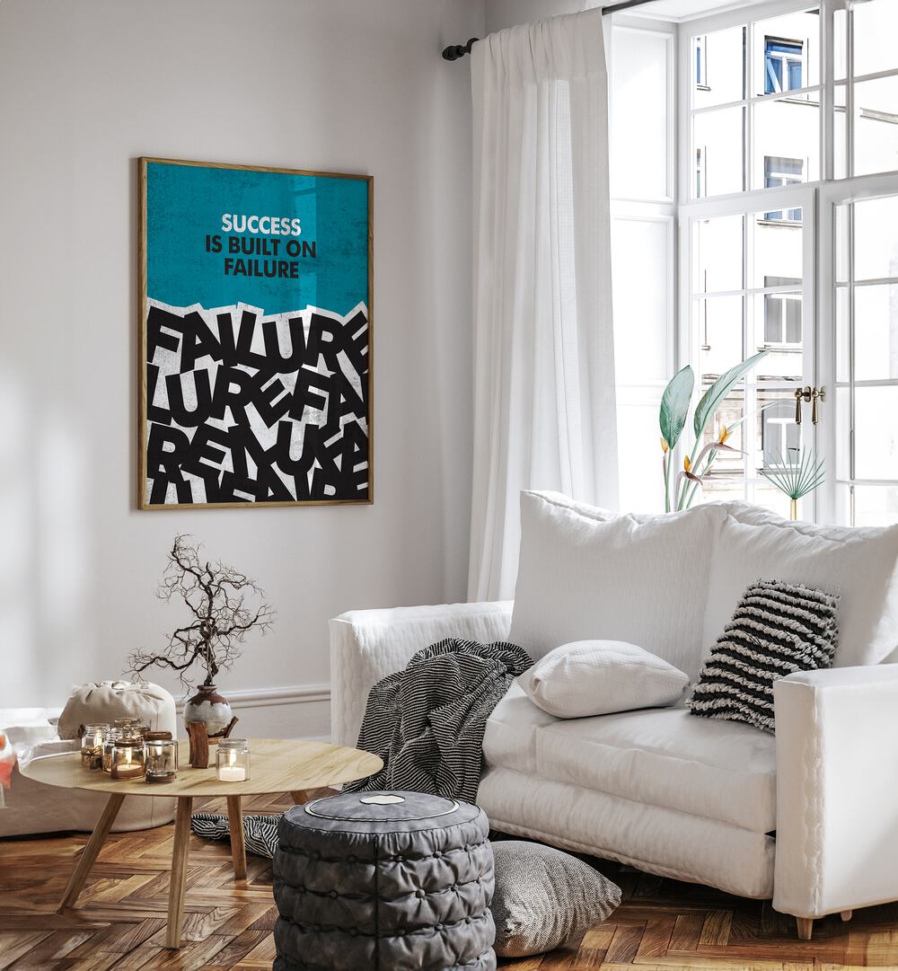 Success Is Built On Failure Quotes And Typography Posters in Oak Wood Plain Frame placed on a White Colored Wall near a White Sofa in the Living Room