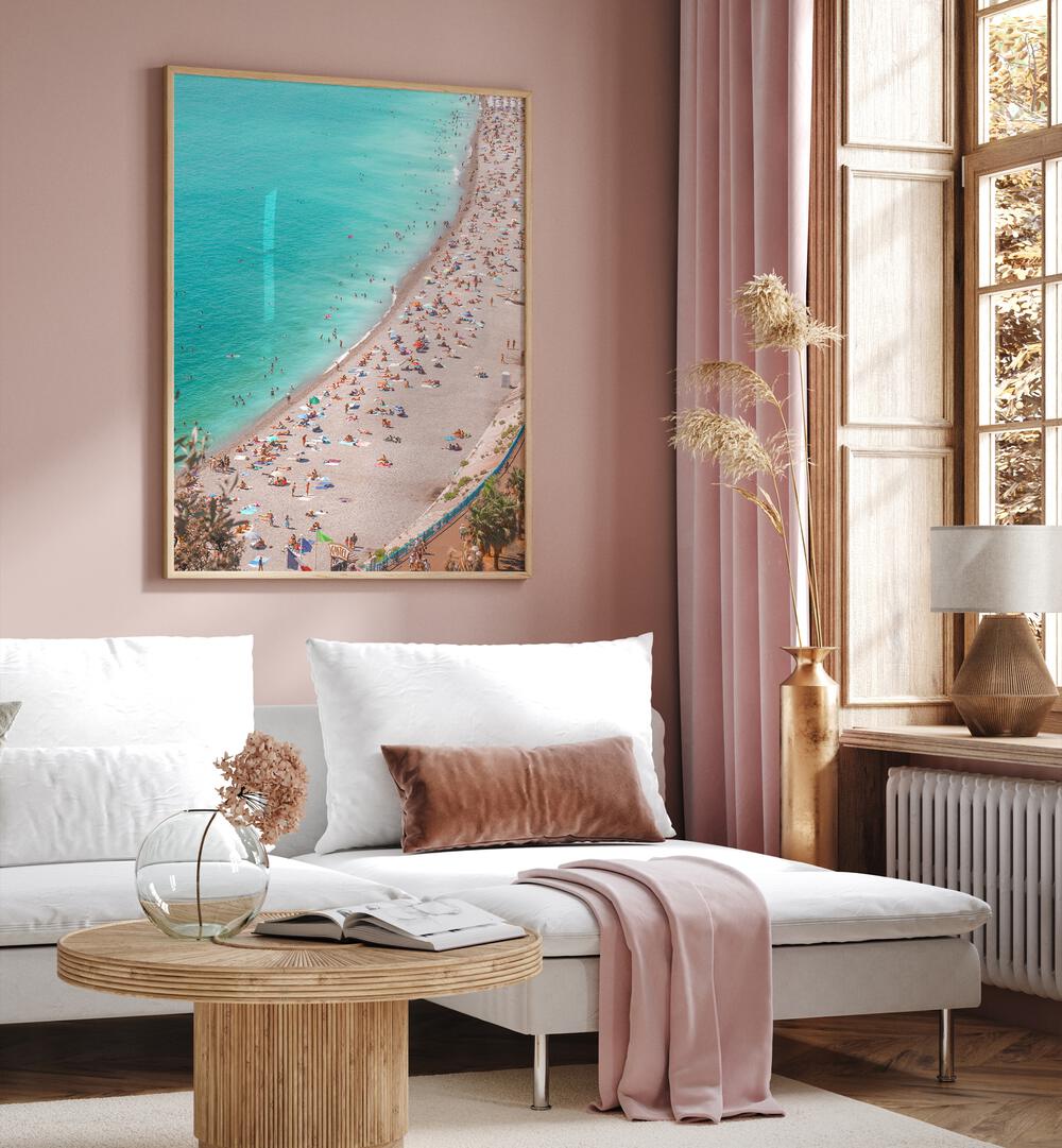 Summer Riviera By Grace Digital Art Co Beach Prints in Oak Wood Plain Frame on a pink wall placed behind a white sofa