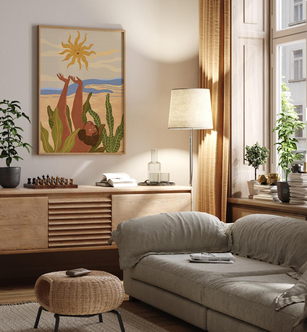 Sun Worship By Arty Guava Wall Art Prints in Oak Wood Plain Frame placed on a Cream Colored Wall above a Console Table near a Grey Sofa in the Living Room