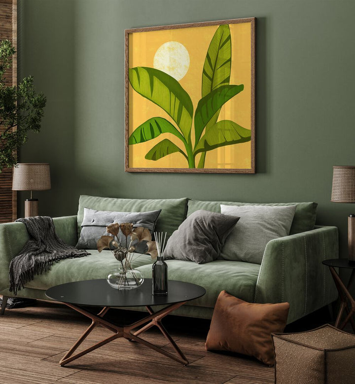 Sunny Golden Tropics by Kristian Gallagher Wall Art Prints in Dark Wood Plain Frame placed on a wall behind a green sofa for living room