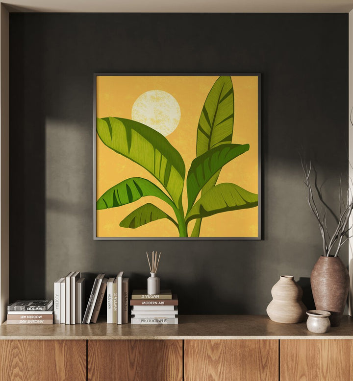 Sunny Golden Tropics by Kristian Gallagher Wall Art Prints in Black Plain Frame placed on a wall behind a table