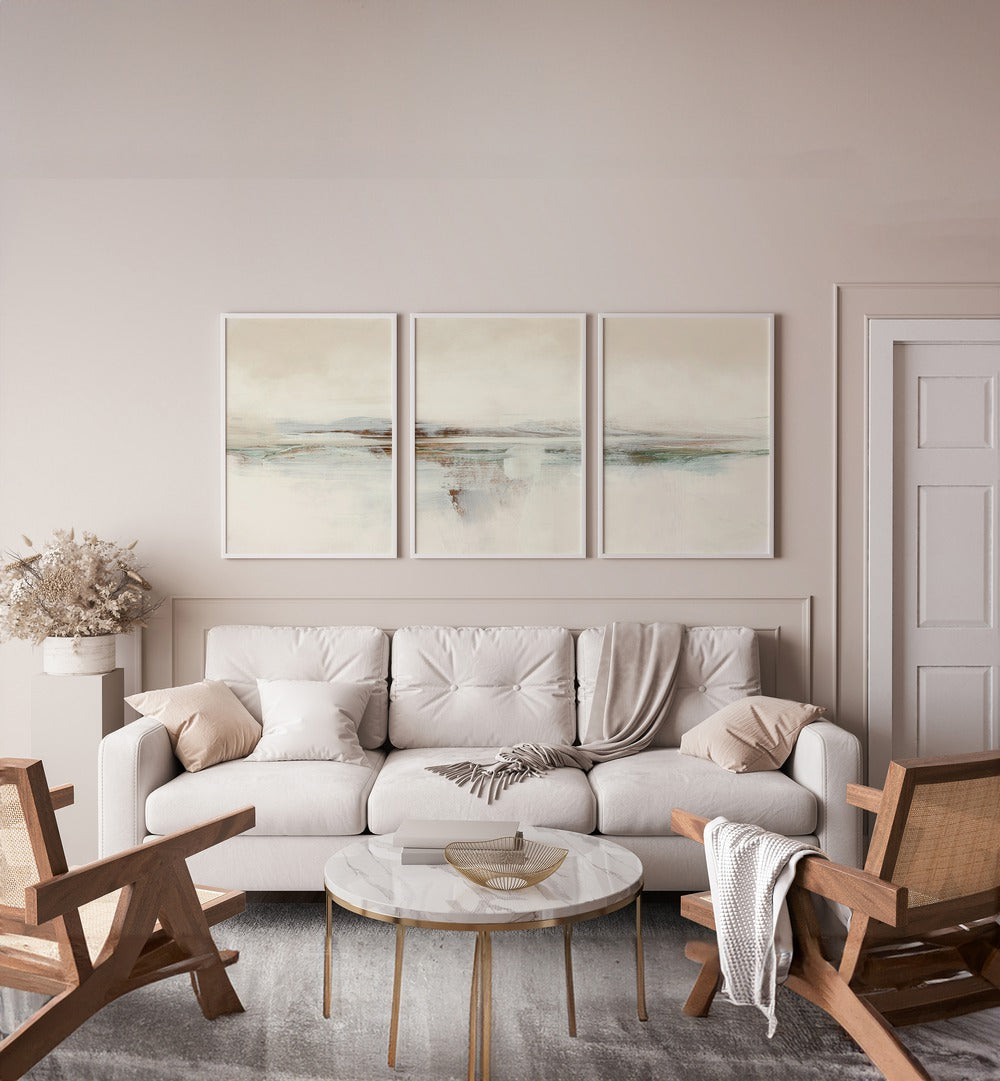 Sunset Abstraction Set Set Of 3 Paintings in White Plain Frame placed on a wall behind a white sofa beside a door for living room