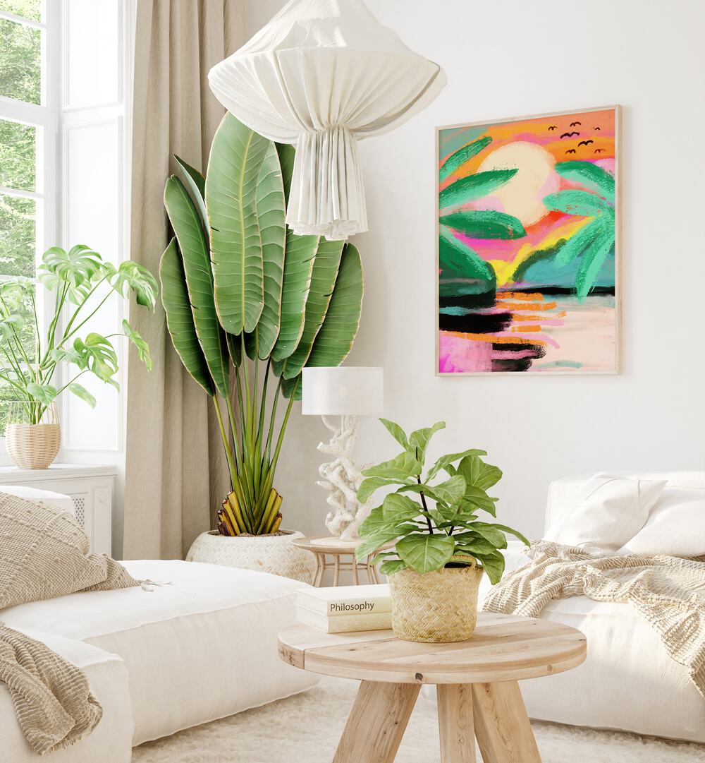 Sunset Island By Treechild Landscape Art Prints in Oak Wood Plain Frame placed on a White Colored Wall near a White  Sofa  in the Living Room