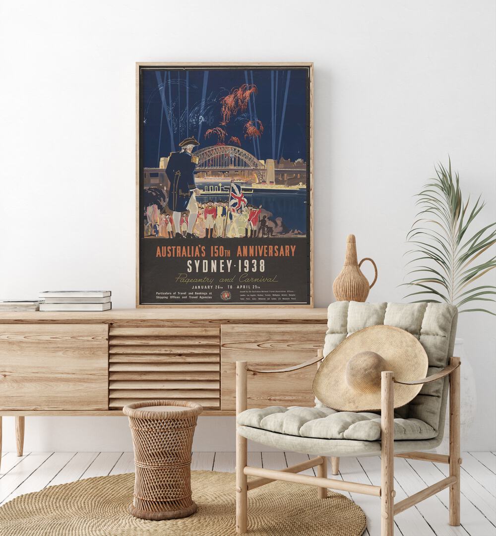 Sydney 1938  Vintage Travel Posters in Oak Wood Plain Frame placed on a console table behind a chair