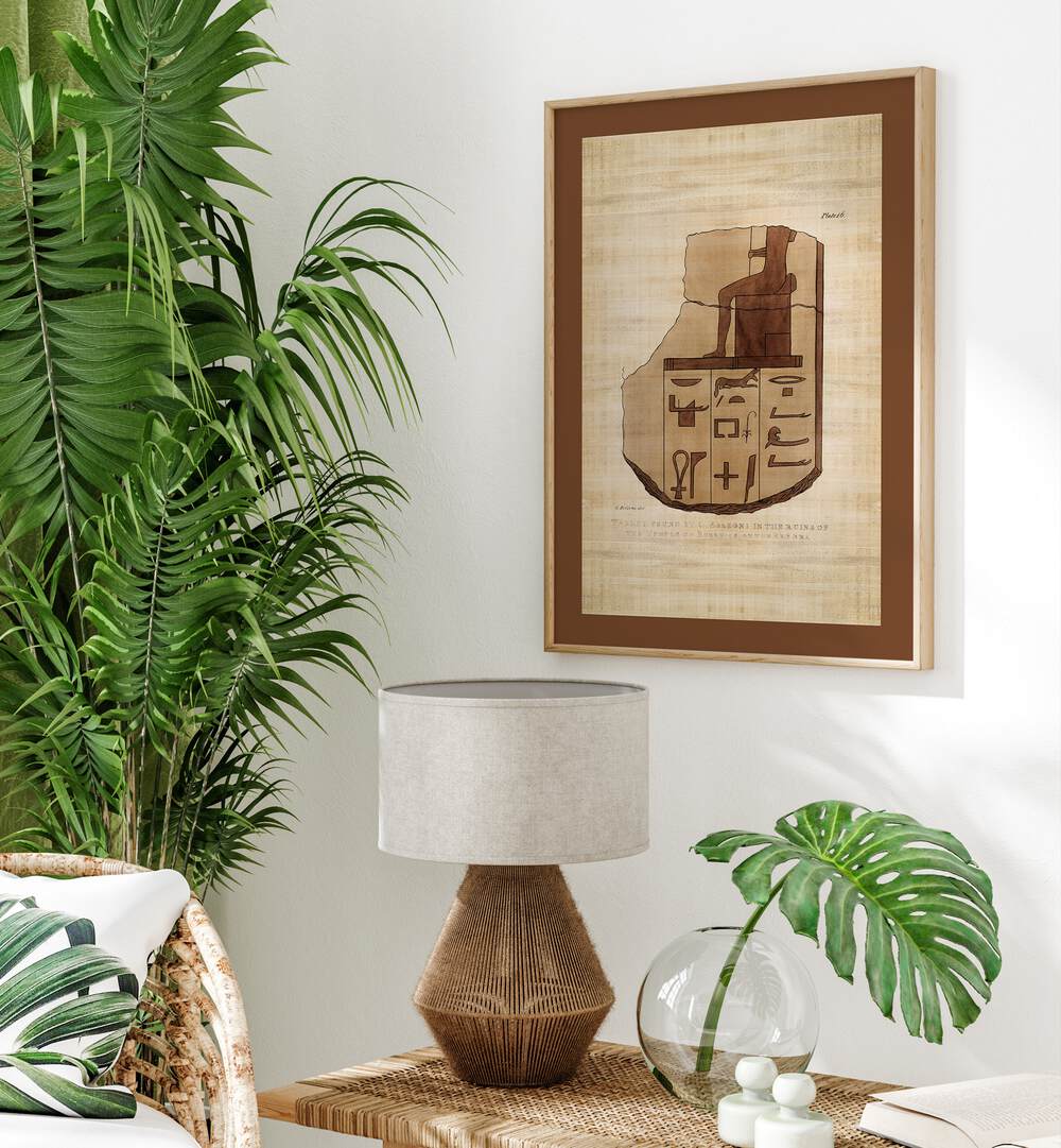 Tablet Of Brecchia Stone With Hieroglyphics Egyptian Art Artwork in oakwood frame with mount on a white wall beside a plant