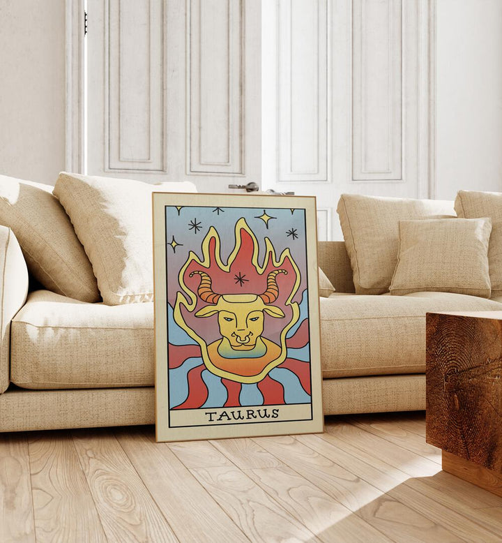 Taurus Zodiac & Tarot Art Painting Artwork in plain oakwood frame beside a sofa