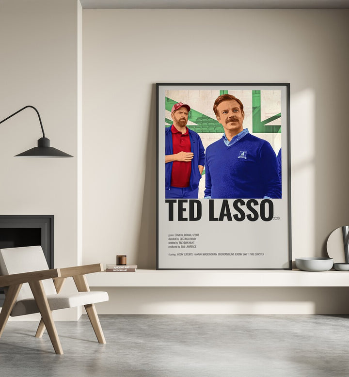 TED LASSO MOVIE POSTERS in Black Plain Frame placed on wall beside chair and lamp