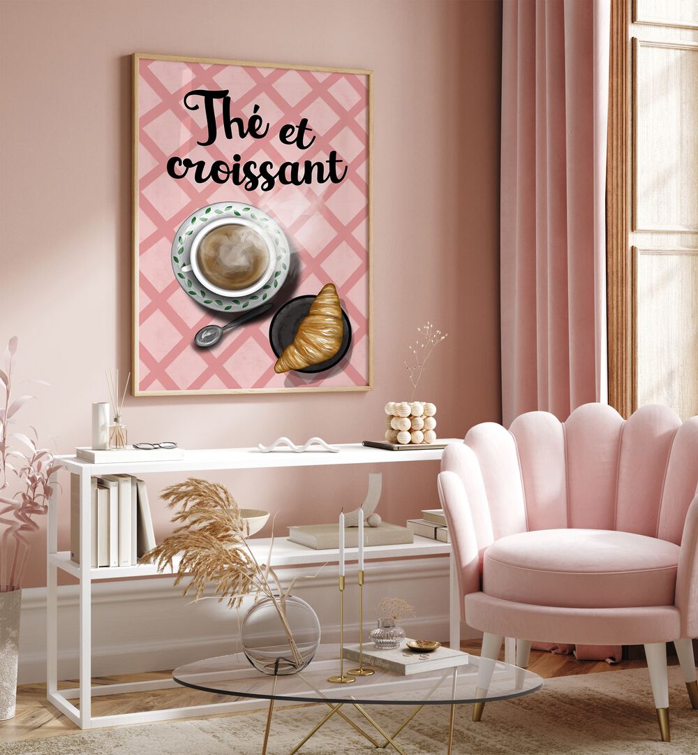 Cozy cafe setting featuring "THE ET CROISSANT , BAR" art, a croissant, and coffee in a stylish pink decor.