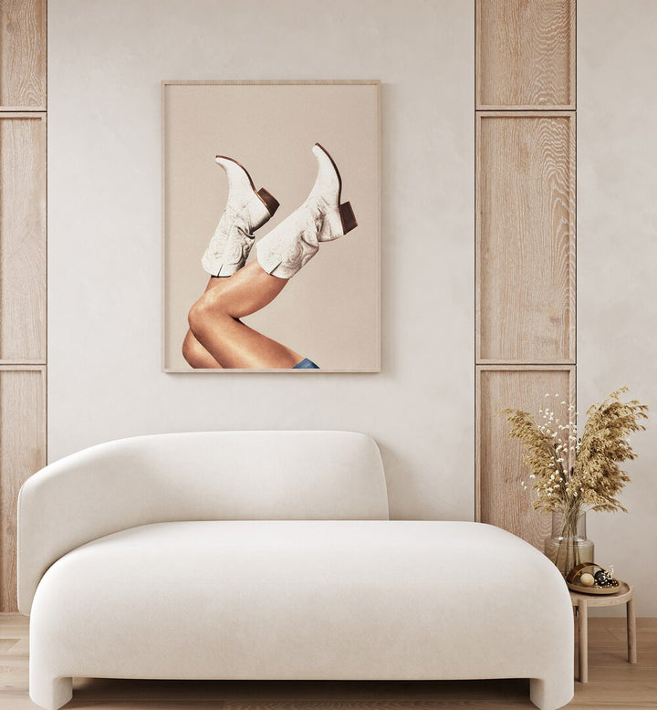 These Boots - Neutral Beige Surreal Art Painting Artwork in plain oakwood frame behind a sofa on a white wall 