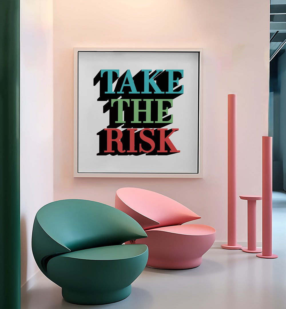 Take the Risk Quotes and Typography Posters in White Floater Frame placed on a wall beside chairs