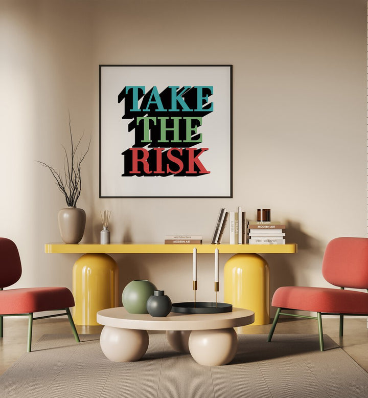 Take the Risk Quotes and Typography Posters in Black Plain Frame placed on a wall behind a table