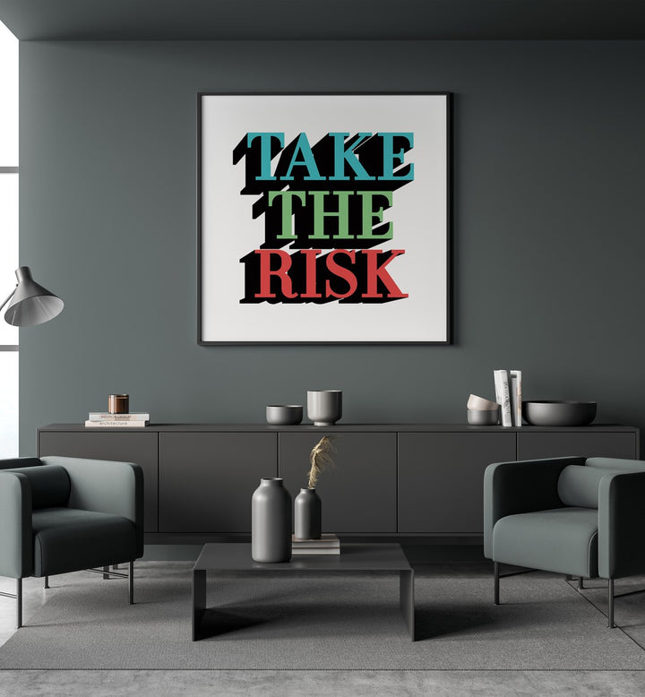 Take the Risk Quotes and Typography Posters in Black Plain Frame placed on a wall behind a black console table