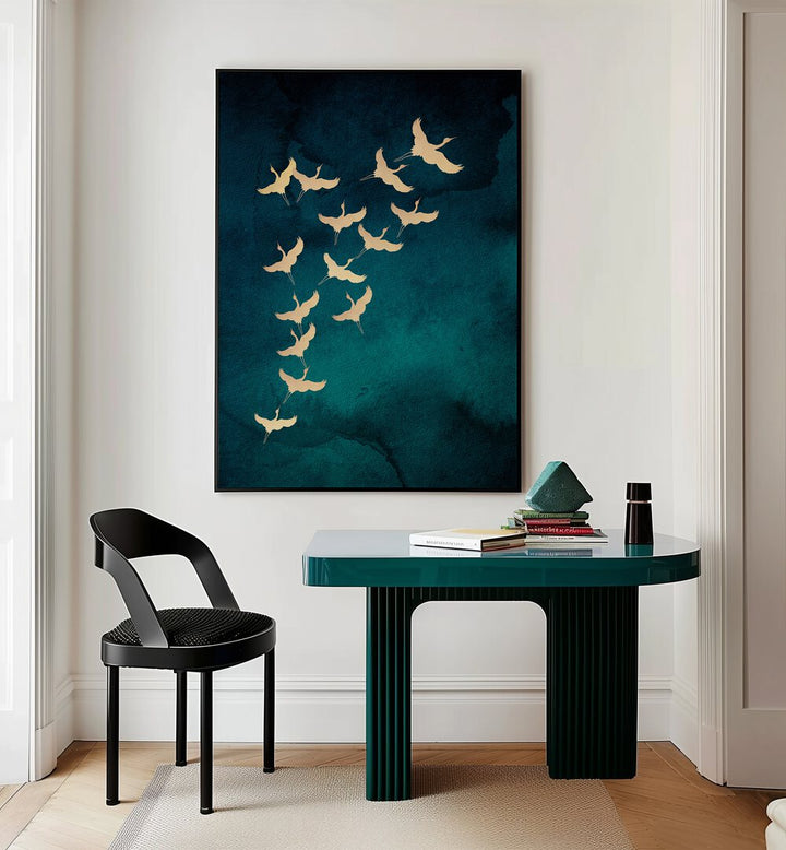 Teal Flying Cranes By Aureous Wildlife Art Prints in Black Plain Frame placed on a Cream Colored Wall near a Table in a Workspace in the Drawing Room