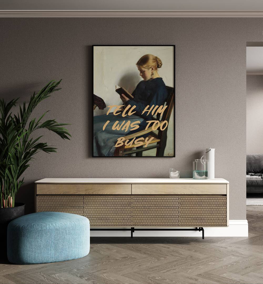 Tell Him I Was Too Busy by the Art Concept Altered Art Prints in Black Plain Frame placed on a wall behind a console table