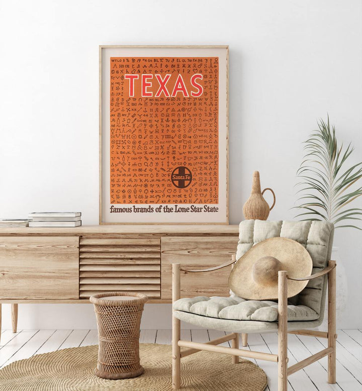 Texas  Retro Travel Posters in Oak Wood Plain Frame placed on a console table behind a chair