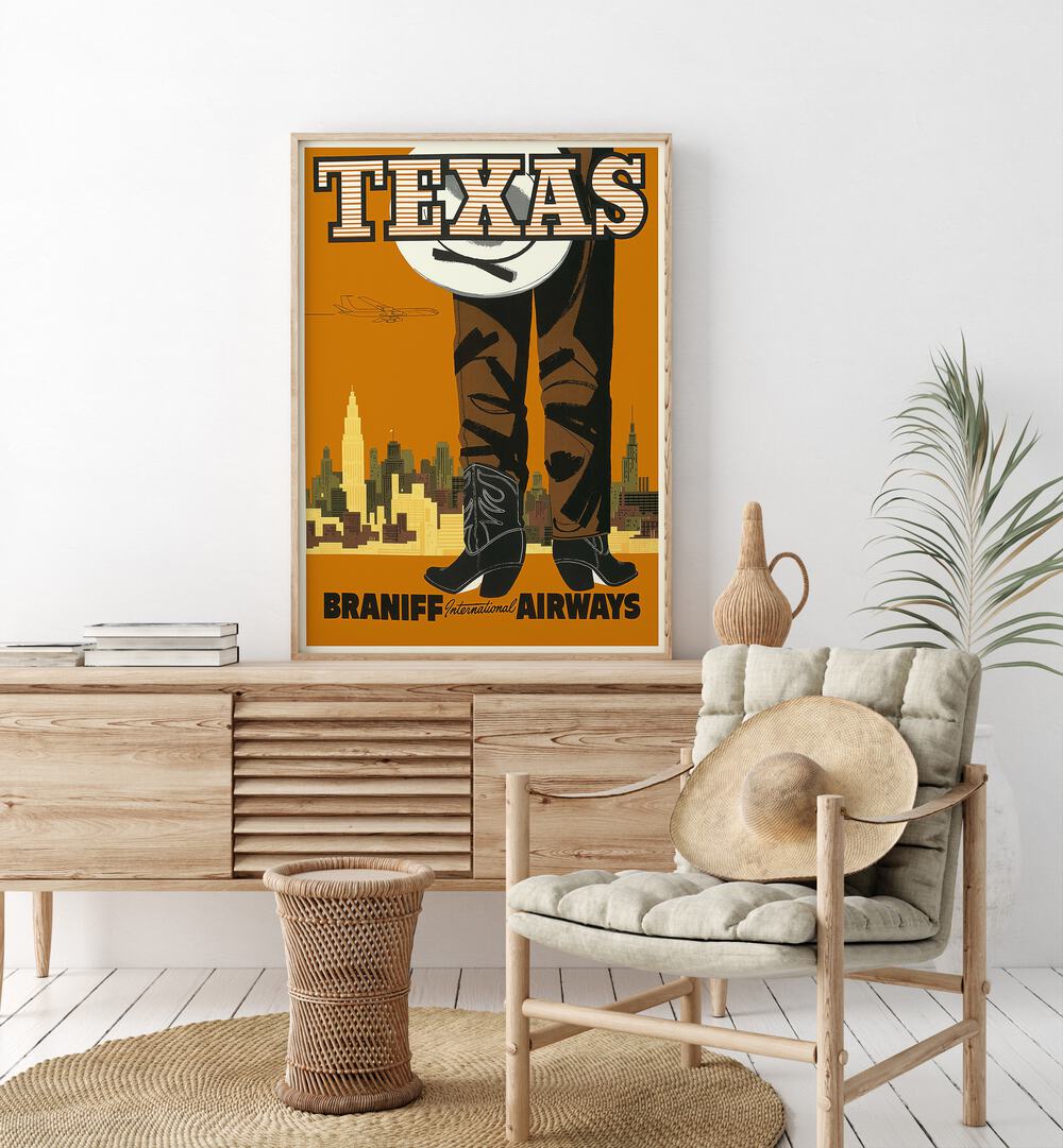 Texas-braniff International Airways  Travel Posters in Oak Wood Plain Frame placed on a console table behind a chair