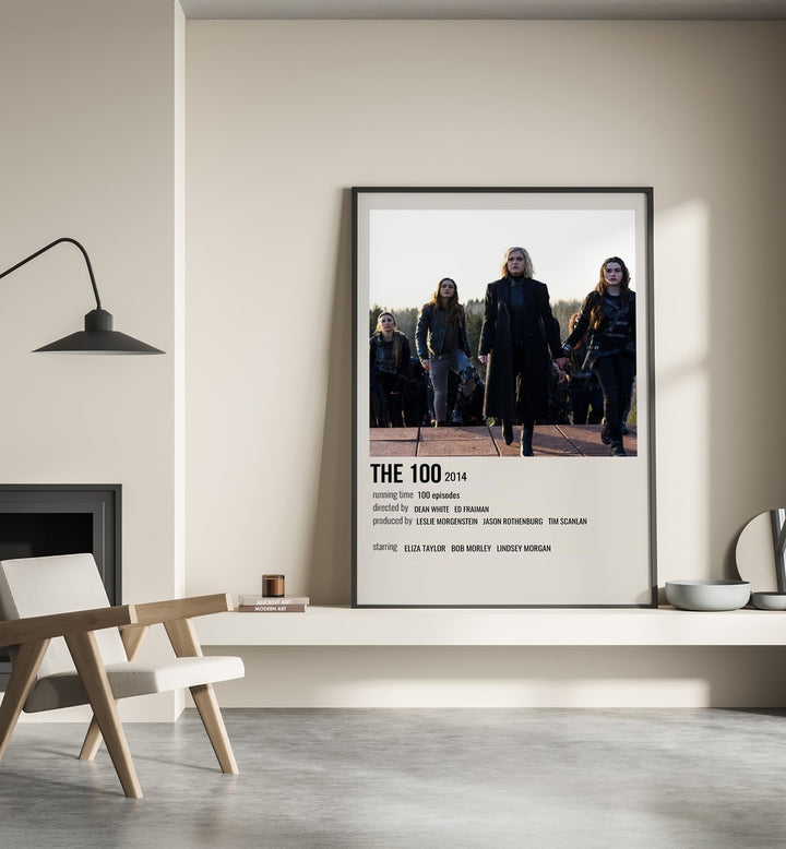 The 100 2014 iii Movie Posters in Black Plain Frame placed on a shelf beside a hearth