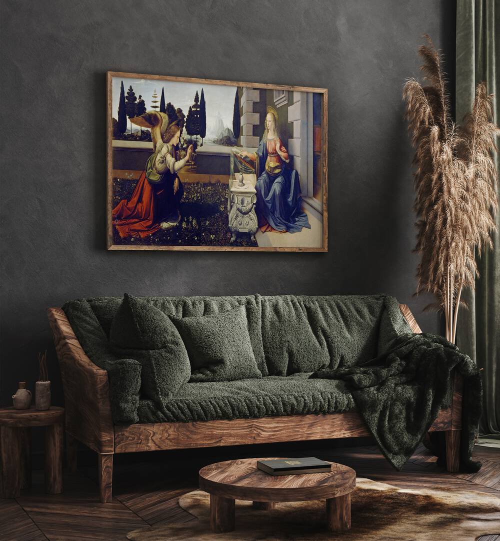 The Annucation Circa 1472 Vintage Paintings in Oak Wood Plain Frame placed on a grey wall behind a green sofa for living room