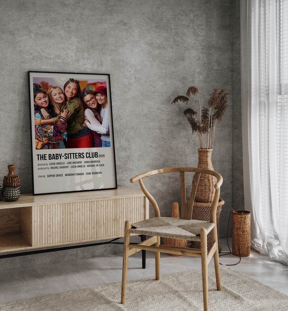 The Baby-sitters Club 2020 Movie Posters in Black Plain Frame placed on a console behind a chair