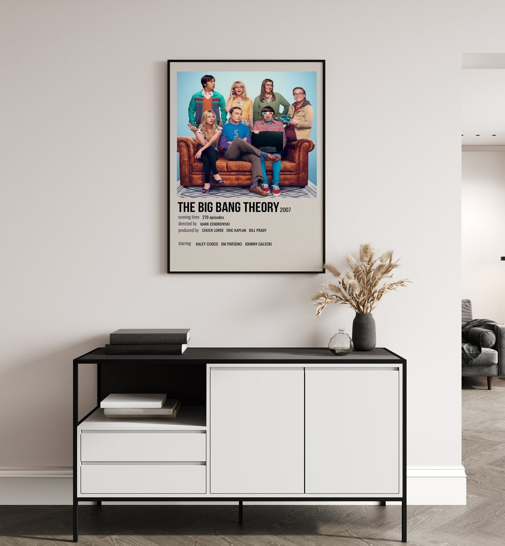 The Big Bang Theory 2007 ii Movie Posters in Black Plain Frame placed on a white wall behind a black and white table