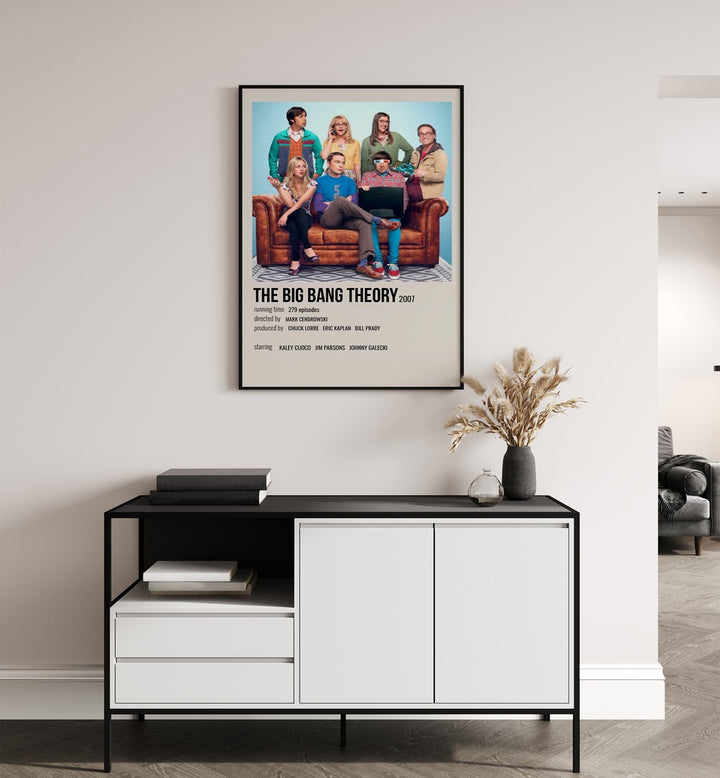 The Big Bang Theory 2007 ii Movie Posters in Black Plain Frame placed on a white wall behind a black and white table