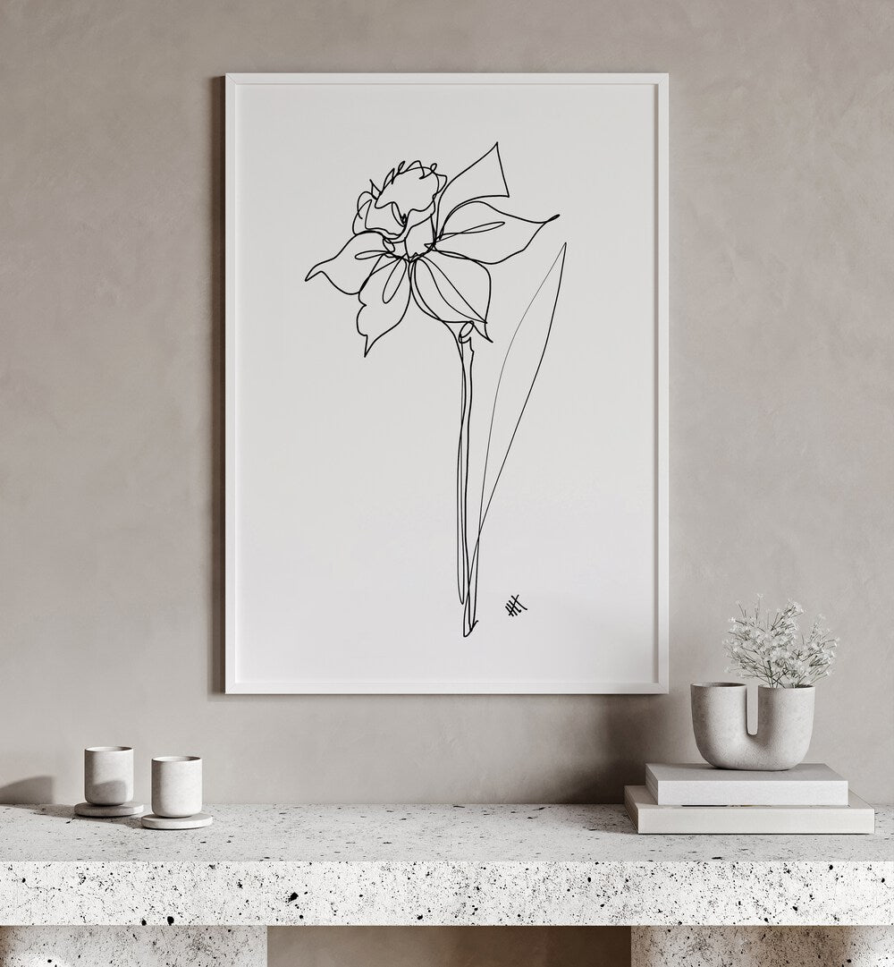 The Daffodil by Hanna Lee Tidd Line Art Paintings Line Art Prints in White Plain Frame placed on a wall behind a table