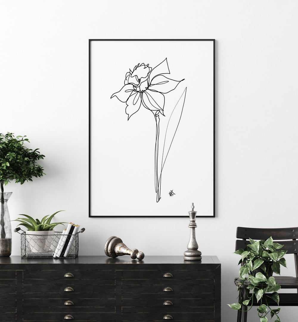 The Daffodil by Hanna Lee Tidd Line Art Paintings Line Art Prints in Black Plain Frame placed on a wall behind a table