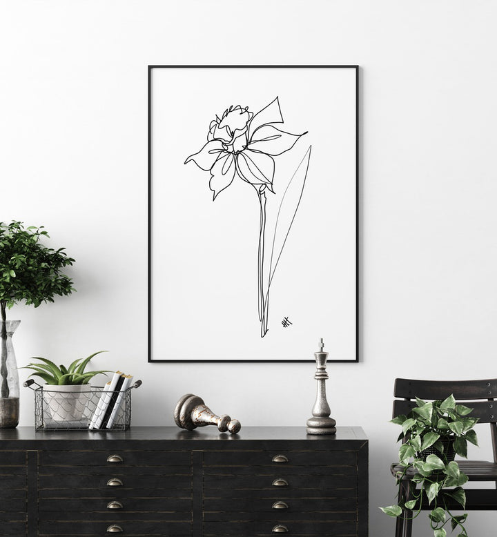 The Daffodil by Hanna Lee Tidd Line Art Paintings Line Art Prints in Black Plain Frame placed on a wall behind a table