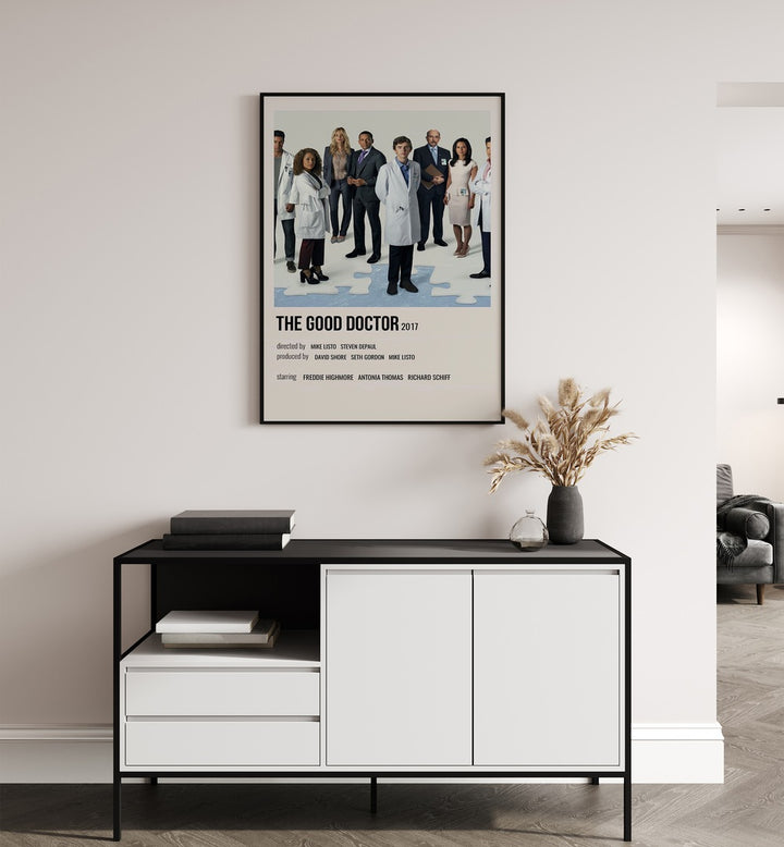 The Good Doctor 2017 Movie Posters in Black Plain Frame placed on a white wall behind a table