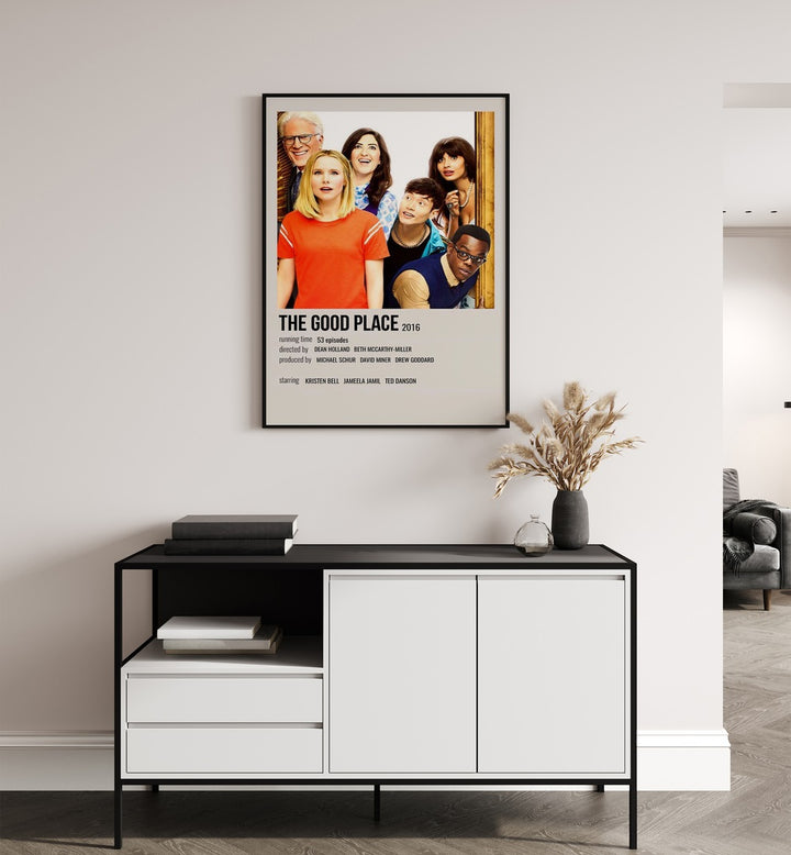 The Good Place 2016 Movie Posters in Black Plain Frame placed on a white wall behind a table