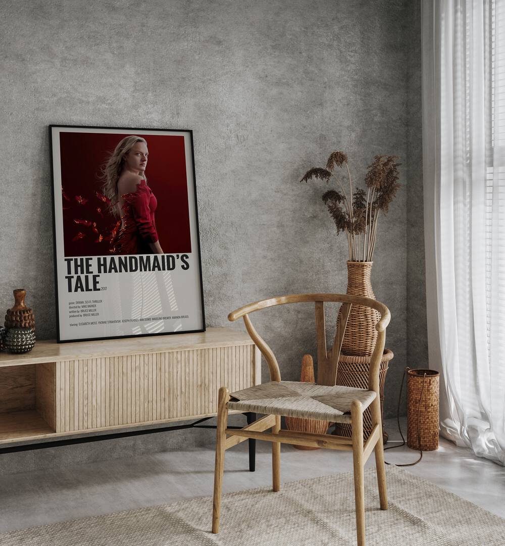 The Handmaids Tale 2017 Movie Posters in Black Plain Frame placed on a console behind a chair