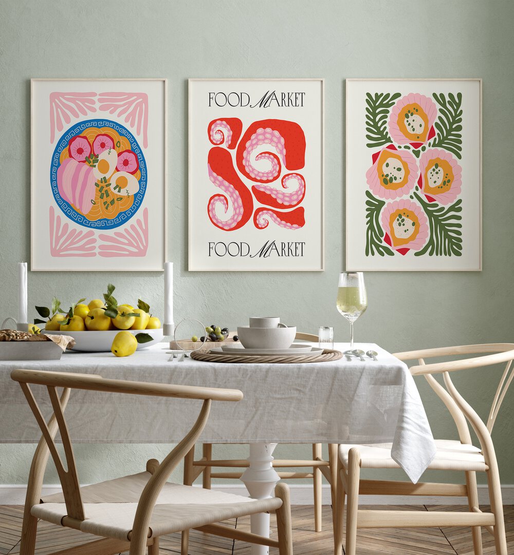 The Kitchen Set Set Of 3 Paintings in White Plain Frame placed on a green wall behind a dining table for dining area