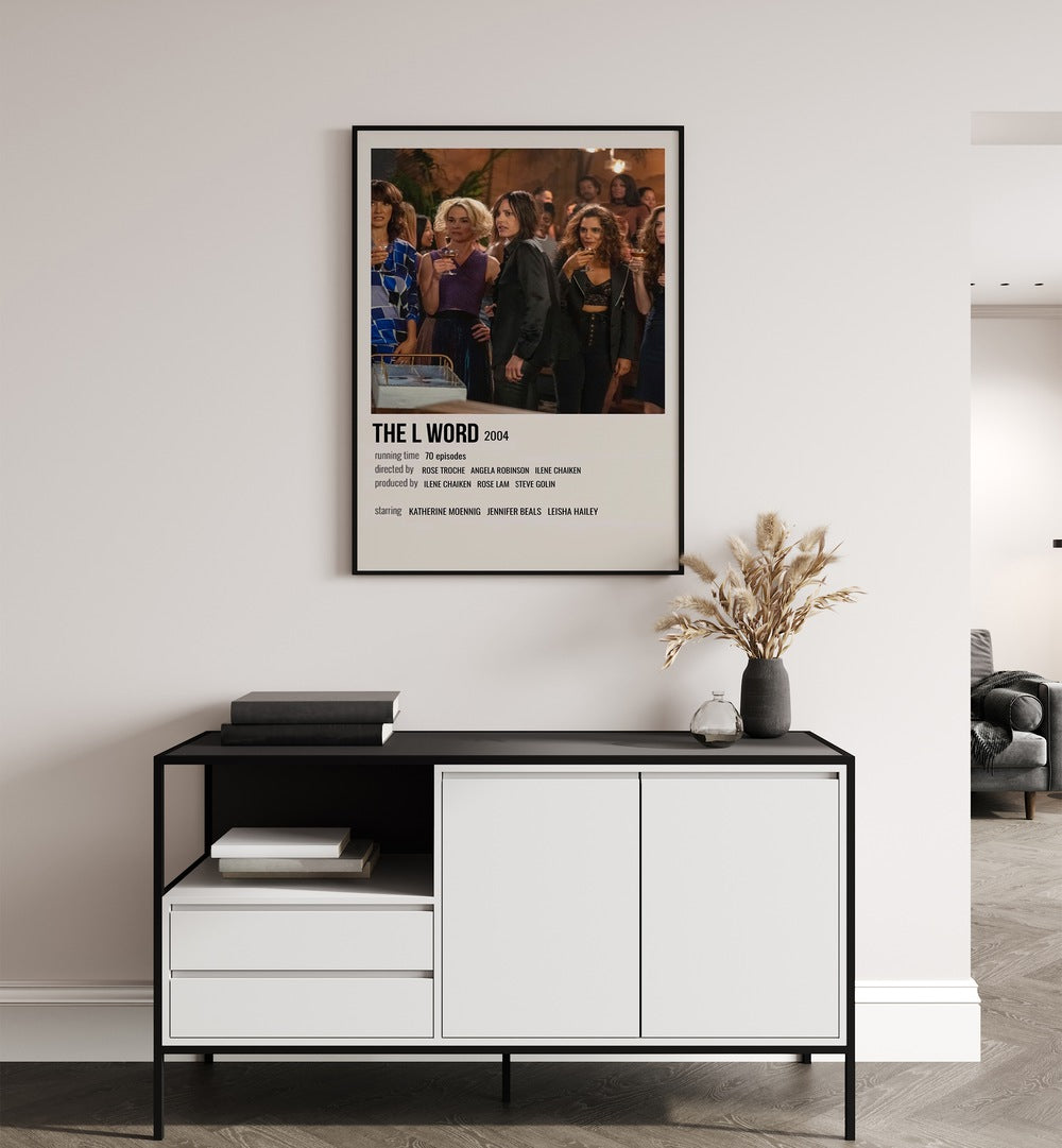 The L Word 2004 Movie Posters in Black Plain Frame placed on a white wall behind a table