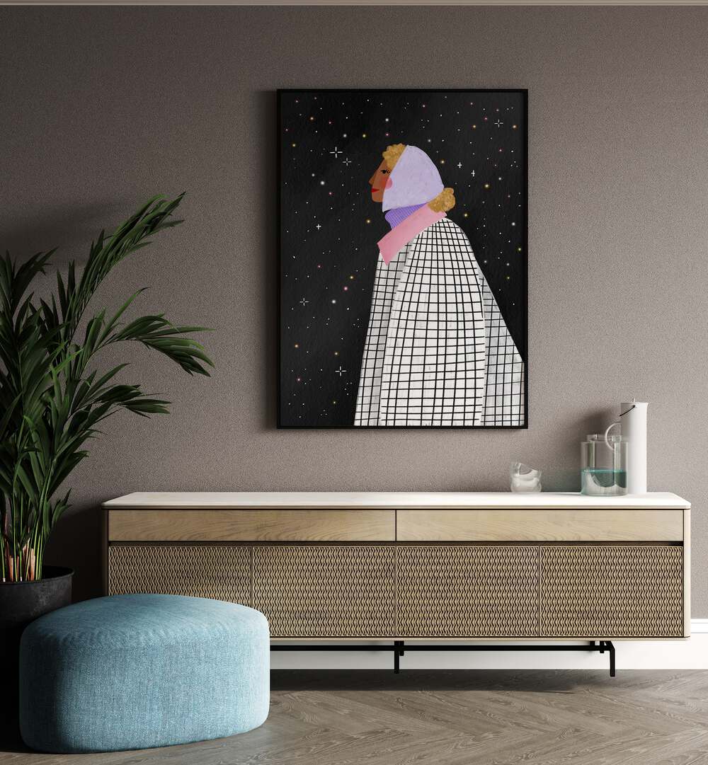 The Lady With The Stars By Bea Muller Women Illustration Paintings in Black Plain Frame on a wall above a console table beside a plant